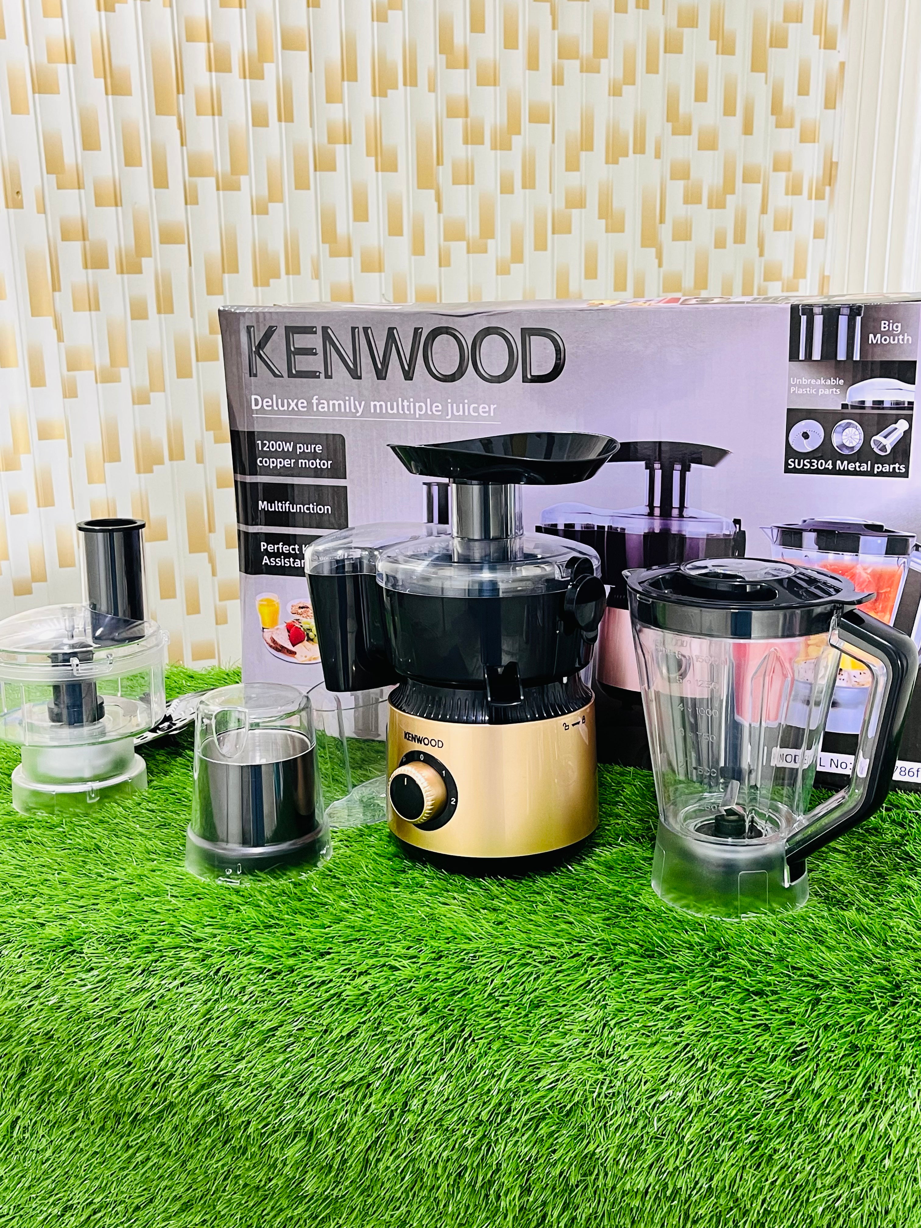 Kenwood juicer on a green surface with packaging in the background